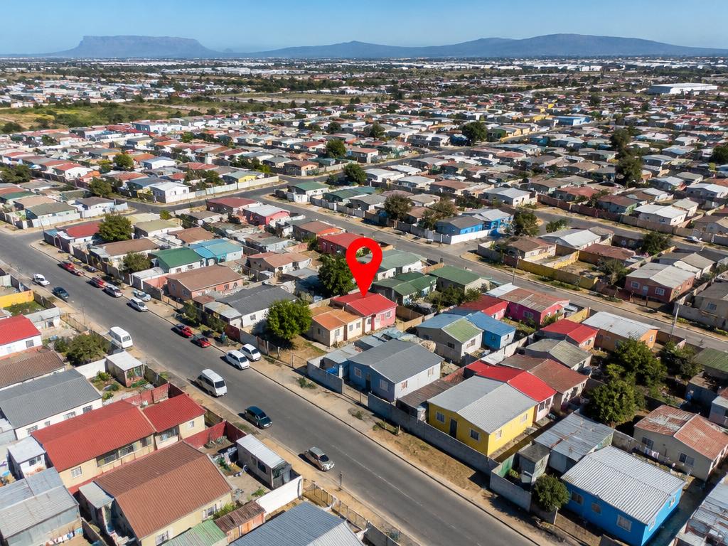 Aerial view of a South African township with a red location pin marking one business